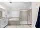 The well-lit bathroom has double sinks, a walk-in shower with glass doors, and a soaking tub at 4611 Los Robles Ct, Palmetto, FL 34221
