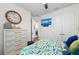 Comfortable bedroom with dresser, TV, closet, and stylish decor creating a cozy and relaxing space at 4611 Los Robles Ct, Palmetto, FL 34221
