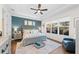 Comfortable bedroom featuring natural light, a ceiling fan, and an ensuite bathroom at 4611 Los Robles Ct, Palmetto, FL 34221