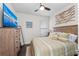 Inviting bedroom featuring a comfortable bed, dresser, ceiling fan, and stylish decor for a serene retreat at 4611 Los Robles Ct, Palmetto, FL 34221