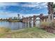 Picturesque stone bridge over a tranquil lake, complemented by lush landscaping and palm trees on a sunny day at 4611 Los Robles Ct, Palmetto, FL 34221