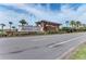 Artisan Lakes community entrance with a brick sign, lush greenery, and a welcoming pergola at 4611 Los Robles Ct, Palmetto, FL 34221