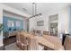 Stylish dining area with rustic table, wicker chairs, and coastal-themed decor and view of kitchen at 4611 Los Robles Ct, Palmetto, FL 34221