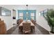 Spacious dining room with a long wooden table, wicker chairs, blue wall accents, and natural light at 4611 Los Robles Ct, Palmetto, FL 34221