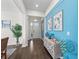 Inviting foyer with coastal decor, dark wood floors, and ample natural light creates a warm entrance at 4611 Los Robles Ct, Palmetto, FL 34221
