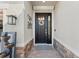Inviting front entry with decorative wreath, stylish light fixture, water feature and stone accents at 4611 Los Robles Ct, Palmetto, FL 34221