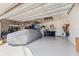 Spacious garage with epoxy flooring, featuring ample storage, tools, and a covered vehicle for ultimate utility at 4611 Los Robles Ct, Palmetto, FL 34221