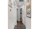 Bright hallway featuring rich wood floors and decorative wall art creating a warm and inviting atmosphere at 4611 Los Robles Ct, Palmetto, FL 34221