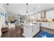 Bright kitchen with island seating, modern appliances, and views of the outdoor living space at 4611 Los Robles Ct, Palmetto, FL 34221