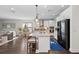 Open-concept kitchen with an island, modern appliances, and seamless flow into the living area at 4611 Los Robles Ct, Palmetto, FL 34221