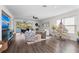 Open living area with comfortable seating, dark wood floors, and access to the outdoor pool and patio at 4611 Los Robles Ct, Palmetto, FL 34221