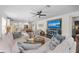 Bright and open living room with hardwood floors, modern furniture, and seamless connection to kitchen at 4611 Los Robles Ct, Palmetto, FL 34221