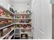 Well-stocked pantry featuring ample shelving for organized storage at 4611 Los Robles Ct, Palmetto, FL 34221