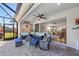 Cozy outdoor patio with comfortable seating, ceiling fan, and serene views, perfect for relaxation and entertainment at 4611 Los Robles Ct, Palmetto, FL 34221