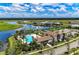 Gorgeous community pool and clubhouse surrounded by palm trees and lush landscaping, creating a resort-like atmosphere at 4611 Los Robles Ct, Palmetto, FL 34221