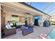 Inviting outdoor living space featuring a screened-in pool, comfortable seating, and an outdoor kitchen setup at 4611 Los Robles Ct, Palmetto, FL 34221