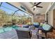 Spacious screened-in pool area, complete with comfortable seating and a stylish outdoor living setup at 4611 Los Robles Ct, Palmetto, FL 34221