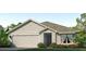 Charming single-story home with a two-car garage, manicured lawn, and simple landscaping at 4615 Dusky Dawn Ln, Palmetto, FL 34221