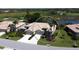 An aerial view of a lovely home near a golf course and water, surrounded by tropical trees and well-kept landscaping at 4629 Samoset Dr, Sarasota, FL 34241