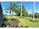 View of lush green backyard with tropical landscaping, mature palm trees, and a walking path at 4629 Samoset Dr, Sarasota, FL 34241
