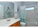 Bright bathroom with a wood vanity, framed mirror, and bathtub with shower at 4629 Samoset Dr, Sarasota, FL 34241