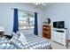 This cozy bedroom offers natural light, blue curtains, and a white dresser at 4629 Samoset Dr, Sarasota, FL 34241