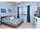 Cozy bedroom with a large window, neutral walls, wood furniture and carpet flooring at 4629 Samoset Dr, Sarasota, FL 34241