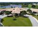 An aerial view of the beautiful clubhouse, with well-maintained landscaping and a circular driveway at 4629 Samoset Dr, Sarasota, FL 34241