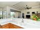 Beautiful kitchen featuring white countertops, stainless steel sink, wood cabinets, and views of the living room at 4629 Samoset Dr, Sarasota, FL 34241