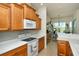 Eat-in kitchen featuring wooden cabinets, white countertops and modern appliances at 4629 Samoset Dr, Sarasota, FL 34241