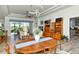 Spacious living area with a modern light fixture, an oval table, and neutral colors, providing a bright and welcoming space at 4629 Samoset Dr, Sarasota, FL 34241