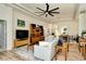 Bright living room with hardwood floors, a ceiling fan, and a modern entertainment center at 4629 Samoset Dr, Sarasota, FL 34241