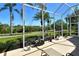 Scenic screened patio featuring outdoor seating and lush green backyard views at 4629 Samoset Dr, Sarasota, FL 34241