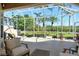 Comfortable screened-in patio featuring views of tropical landscaping at 4629 Samoset Dr, Sarasota, FL 34241