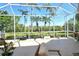 Large screened-in patio with seating area and picturesque backyard view at 4629 Samoset Dr, Sarasota, FL 34241
