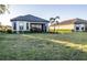 Expansive backyard with lush lawn, screened lanai, and meticulous landscaping offers serene outdoor living at 4747 Motta Ct, Bradenton, FL 34211
