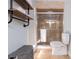 This is a bathroom with wood shelving and a glass shower with a sliding door at 4807 W Country Club Dr, Sarasota, FL 34243