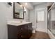 Bathroom featuring modern vanity, mirror, and a door leading to the exterior at 4807 W Country Club Dr, Sarasota, FL 34243