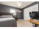 Modern bedroom with a gray bed, a computer desk and a white closet at 4807 W Country Club Dr, Sarasota, FL 34243