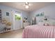 Charming bedroom with a pink bed, a white dresser and a window with curtains at 4807 W Country Club Dr, Sarasota, FL 34243