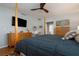 This bedroom features hardwood floors, a four-poster bed and warm wall paint at 4807 W Country Club Dr, Sarasota, FL 34243