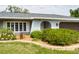 Close-up shot of the property showcasing the meticulously landscaped front yard with well-maintained shrubs and colorful flowers at 4807 W Country Club Dr, Sarasota, FL 34243