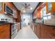Well lit kitchen featuring stainless steel appliances, wood cabinets and black countertops at 4807 W Country Club Dr, Sarasota, FL 34243