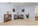 Cozy living room with tile floors, seating, and a bookshelf with books at 4807 W Country Club Dr, Sarasota, FL 34243