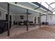 An outdoor patio is furnished with wicker seating and a ceiling fan for comfortable relaxation at 4807 W Country Club Dr, Sarasota, FL 34243