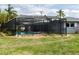 A backyard pool has tropical plants, a screened enclosure, and is well maintained at 4807 W Country Club Dr, Sarasota, FL 34243