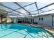 Relaxing screened-in pool area with a spa, perfect for outdoor entertaining and enjoying sunny days at 4807 W Country Club Dr, Sarasota, FL 34243