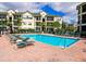 Community pool with lounge chairs and lush landscaping, set against a backdrop of residential buildings at 5168 Northridge Rd # 209, Sarasota, FL 34238