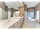 This elegant bathroom features a tub, shower, vanity with double sinks, and white tile floors at 5224 88Th E St, Bradenton, FL 34211
