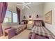 Cozy bedroom featuring two twin beds with plaid bedding, matching benches, and natural light from the window at 5224 88Th E St, Bradenton, FL 34211
